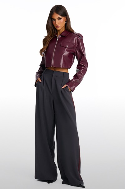 Model in burgundy tailored pants