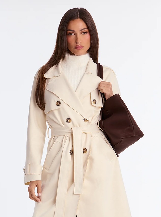 Model in a cream double-breasted fall coat
