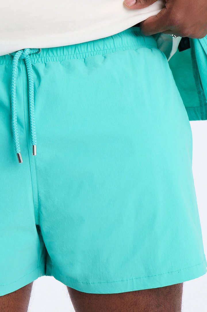 Montez Stretch Swim Trunk 4″ - Teal