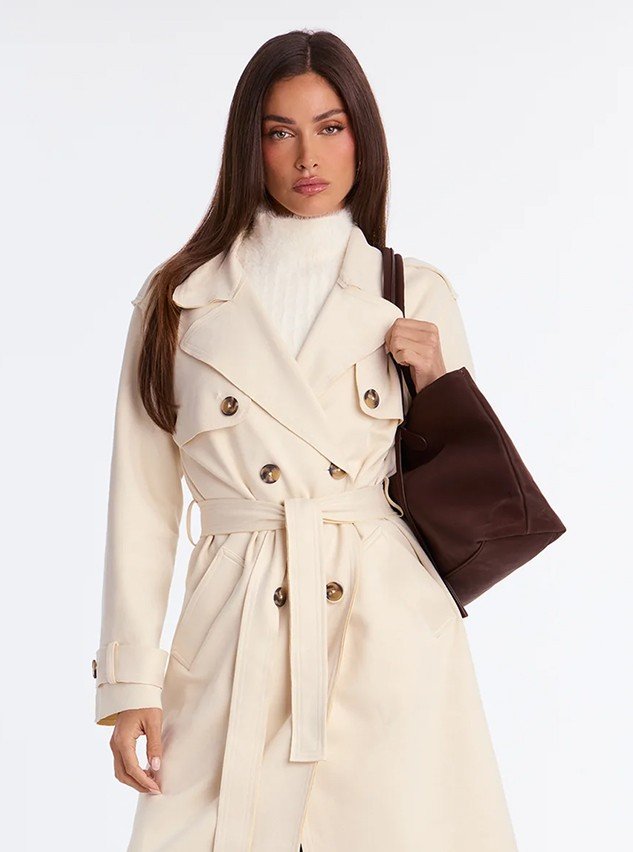 Model in a cream double-breasted fall coat